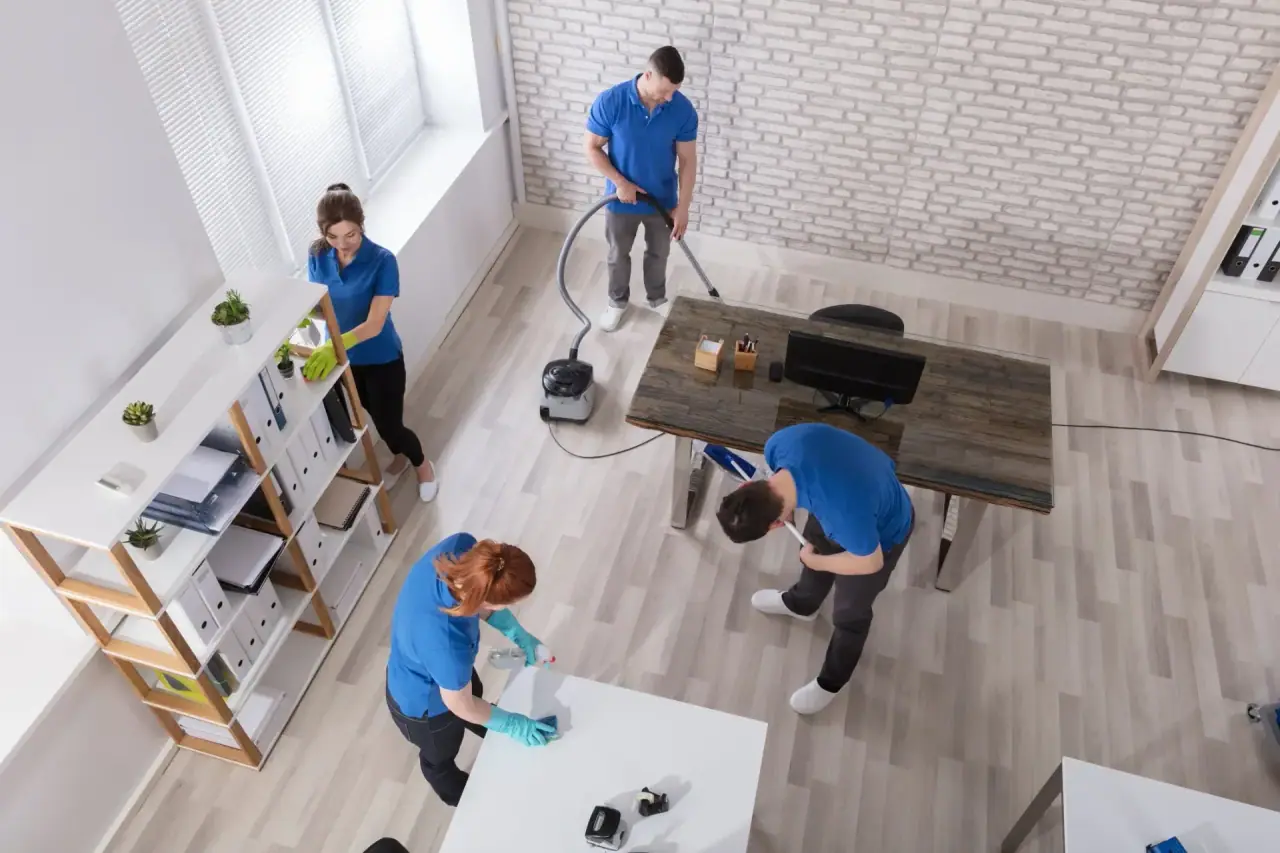 CQD cleaners working methodically across a bright commercial office