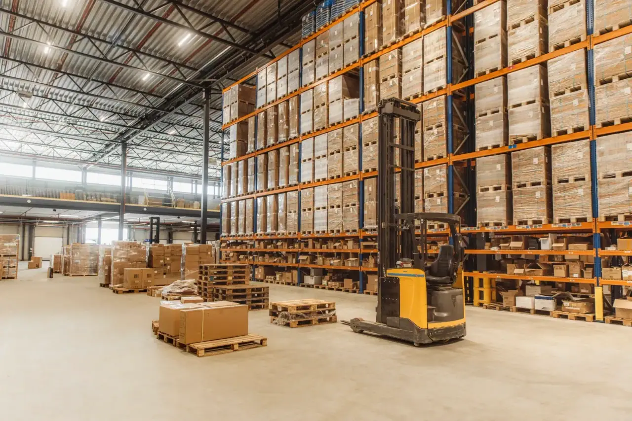 Organised warehouse aisle with high pallet racking and clear operational routes